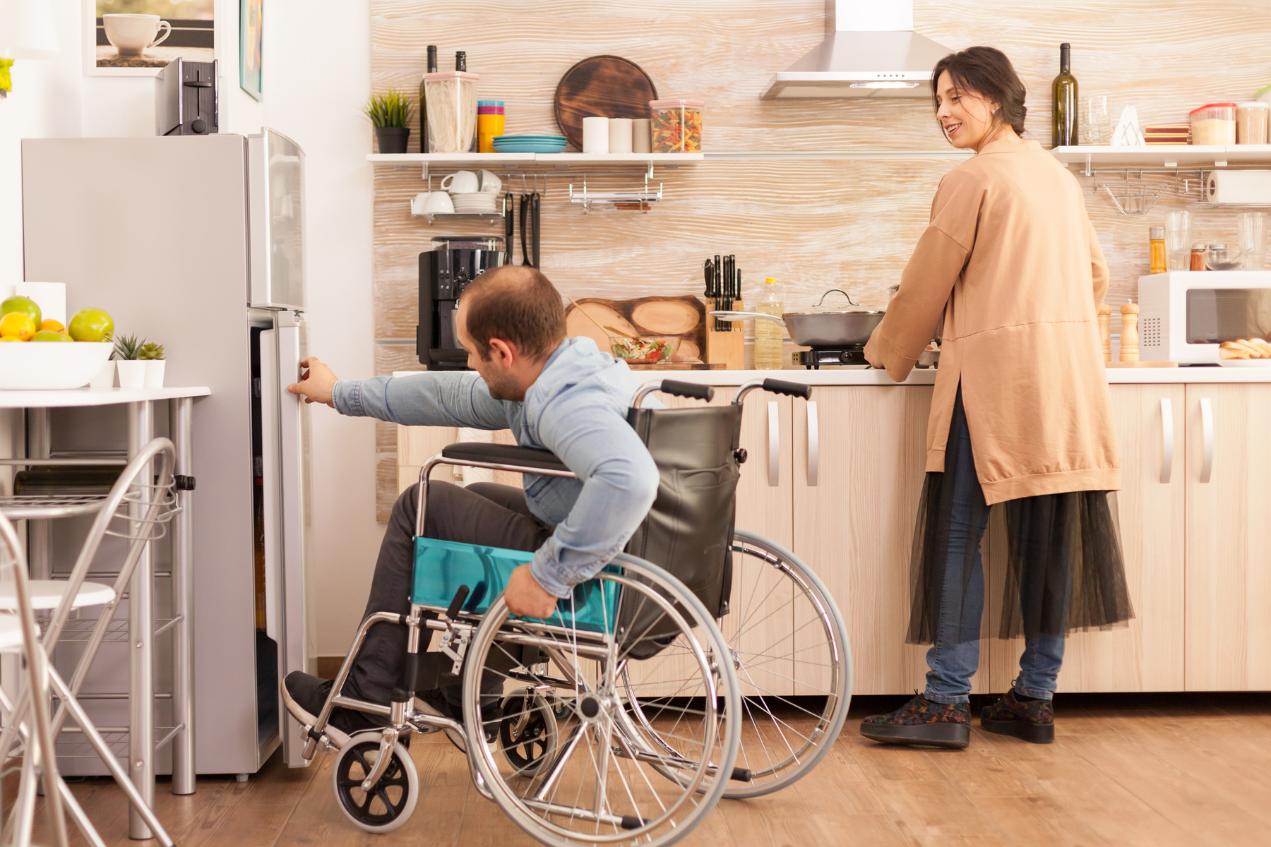 Une femme se demande si elle doit aider son mari handicapé pour ouvrir une porte